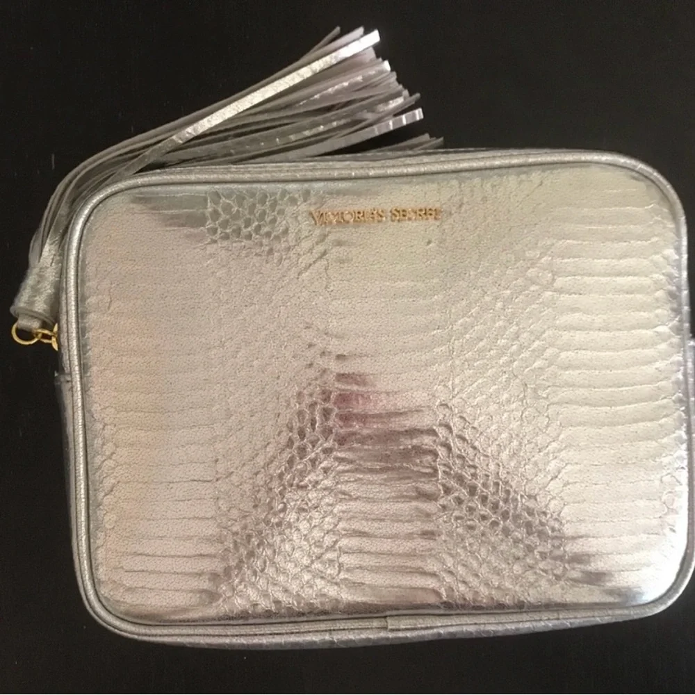 Victoria’s Secret silver snake skin purse with gold chain strap.
